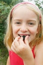 Girl eating wild blackberries