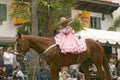 Young girl in pink dress rides horse in annual Old Spanish Days Fiesta held every August in Santa Barbara, California