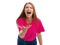 A young girl loudly screams and indignantly gesturing with her hand. Isolated on white background.