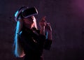 Young girl play virtual reality game wear vr glasses and explore alternative reality. woman in cyber space and virtual gaming