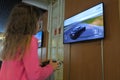 Young girl playing Auto racing on Sony PlayStation