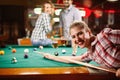 Young girl playing billiard in club