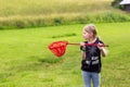 Young girl playing with a butterfly net on the meadow Royalty Free Stock Photo