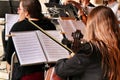 Young girl playing the cello in an orchestra on the street Royalty Free Stock Photo