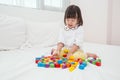 Young girl playing with colorful wooden box