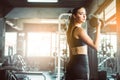 Young girl playing dumbbell to exercise in fitness.Slim girl lifts heavy dumbbell while training in the gym. Sports concept fat b Royalty Free Stock Photo