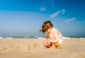 Pretty little girl making sandcastles on the beaches of Hauts-de-France Royalty Free Stock Photo