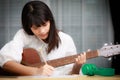 Young girl playing guitar and compose music Royalty Free Stock Photo