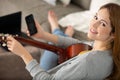 young girl playing guitar and recording music in computer Royalty Free Stock Photo
