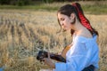 Young girl playing the guitar on straw field Royalty Free Stock Photo