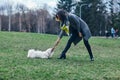 Young girl playing with her dog on grass Royalty Free Stock Photo