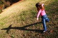 Young girl playing with her shadow