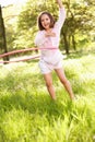 Young Girl Playing With Hula Hoop In Field Royalty Free Stock Photo