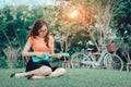 Young girl playing music ukulele outdoor Royalty Free Stock Photo