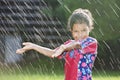 Young girl playing in the rain