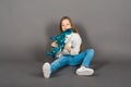 Young girl playing with shark toy in a yellow studio