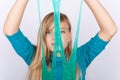 Young girl playing with slime holding it in front of her face Royalty Free Stock Photo