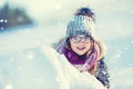 Young girl are playing with snow.Beauty Winter happy Girl Blowing Snow in frosty winter park or outdoors. Girl and winter cold we Royalty Free Stock Photo
