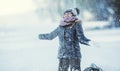 Young girl are playing with snow.Beauty Winter happy Girl Blowing Snow in frosty winter park or outdoors. Royalty Free Stock Photo