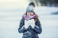 Young girl are playing with snow.Beauty Winter happy Girl Blowing Snow in frosty winter park or outdoors. Royalty Free Stock Photo