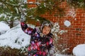 Young girl are playing with snow.Beauty Winter happy Girl Blowing Snow in frosty winter park or outdoors. Royalty Free Stock Photo