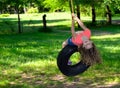 Young girl playing on a tire swing Royalty Free Stock Photo