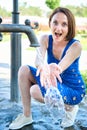 Young girl playing with water squirt and making splashes