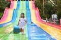 A young girl playing on a waterslide at waterpark in Asia