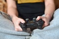 A young girl plays video games with a black joystick with many b Royalty Free Stock Photo