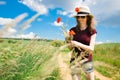 A young girl is plucking a poppy flowers - sunny day Royalty Free Stock Photo