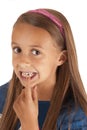 Young girl pointing to lost tooth in her mouth Royalty Free Stock Photo