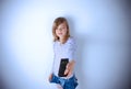 Young girl pointing with the TV remote control and pushing the p Royalty Free Stock Photo