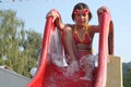 Young girl on a pool slide