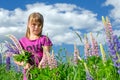 Young girl portrait in lupine flowers field