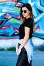 Urban Beauty: Fashionable Teens Strike a Pose in Vibrant Graffiti Setting Royalty Free Stock Photo