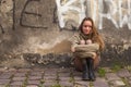 Young girl posing near a stone wall in the old town. Royalty Free Stock Photo