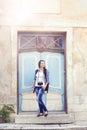 Young girl posing next to a vintage door Royalty Free Stock Photo