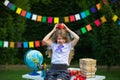 Young girl posing with red Newton apple against flags background. Back to school Royalty Free Stock Photo