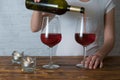 Young girl pouring red wine into glass on romantic party Royalty Free Stock Photo