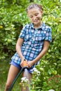 Young girl pours water from hose Royalty Free Stock Photo