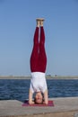 Young girl practices yoga on the shore of the lake, the concept of enjoying privacy and concentration, sunlight