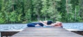 Young  girl  practicing yoga in the nature on the lake. Female happiness. Landscape background, Panoramic view Royalty Free Stock Photo