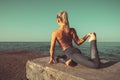 Young girl practicing yoga outdoors near sea. Harmony and meditation concept. Healthy lifestyle and fitness Royalty Free Stock Photo