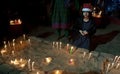 The young girl is praying for Christmas eve with candle lights. Royalty Free Stock Photo