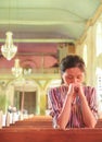 Young girl praying in church Royalty Free Stock Photo