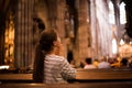 Young girl praying in church Royalty Free Stock Photo