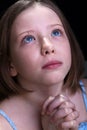 Young girl praying and crying