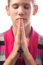 Young girl praying while holding cross Royalty Free Stock Photo