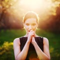 A young girl prays at sunset Royalty Free Stock Photo