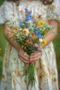 A young girl presents a bouquet of wildflowers